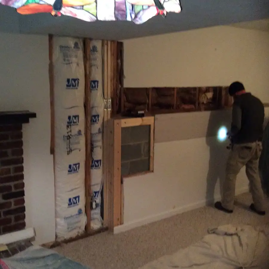 Restoration technician inspecting water damage in Groves